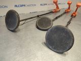 three old frying pans on a metal table