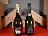two bottles of wine sitting next to each other on a table
