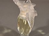 a small glass vase with a white flower inside of it