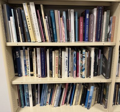 a bookshelf with many books on it in a room