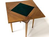 a wooden table with a green cloth on top of it