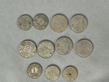 six different types of coins are shown on a white surface