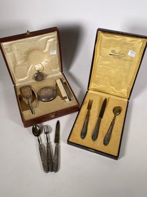 deux pièces d'argenterie dans un coffret posé sur une table