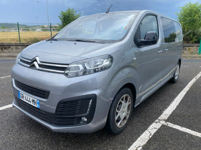 citroen van parked in a parking lot with a cloudy sky in the background