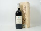 a bottle of wine sitting next to a wooden box