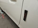 a close up of a white car with a clock on the door