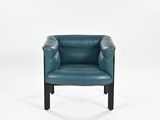 the blue leather chair is sitting on a white surface