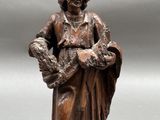 statue of a woman holding a basket of flowers