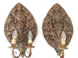 pair of antique wall sconces with ornate carvings and candle holders