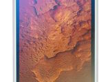 an aerial view of a desert landscape with a blue sky