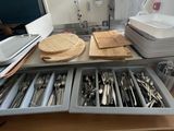 a drawer full of utensils and knives on a table