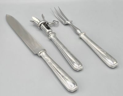 three forks and a knife on a white table