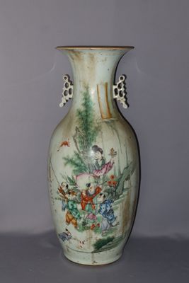 a vase with a painting on it sitting on a table