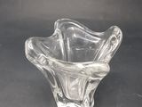 clear glass bowl sitting on a black surface with a black background