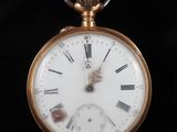 une montre de poche en or avec des chiffres romains sur le cadran