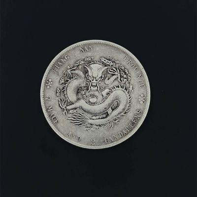 an old silver coin with a dragon on it on a black background