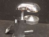 a metal object that is sitting on a black surface