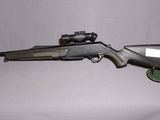 the rifle is laying on the table next to the bag