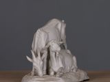 a statue of a cow and a calf on a table