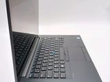 a laptop computer sitting on a table with its lid open