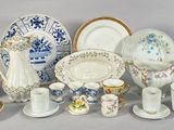 many different types of porcelain dishes and cups on the table