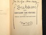 an open book with a handwritten title on it sitting on a black surface