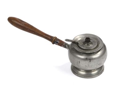 an old metal tea pot with a wooden handle on a white surface
