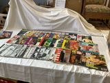 a lot of magazines on a table covered with a white cloth