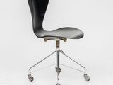 a black office chair with wheels on a white background