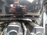 a man taking a picture of himself in the mirror of a motorcycle