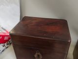 a small wooden box sitting on a table next to other items