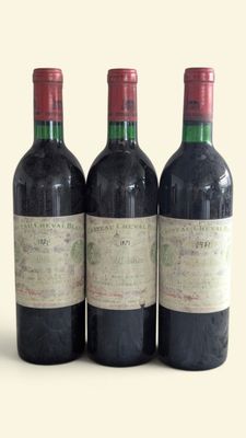 three bottles of wine are lined up in a row on a table