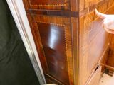 a man standing in front of a dresser in a bathroom