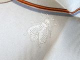 a close up of a white shirt with a brown stripe on it