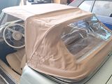 a car with a cover on top of it in a garage