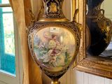 a vase sitting on a table in front of a mirror