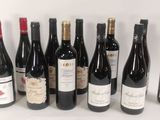 several bottles of wine are lined up in a row on a white surface