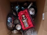 a cardboard box filled with many different types of pots and pans