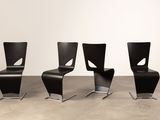 three black chairs sitting next to each other in a room