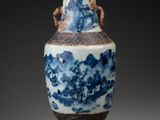 a blue and white vase sitting on a table