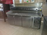 stainless steel counter top in a commercial kitchen with a refrigerator