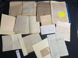 many old papers on a black table with a yellow sticker