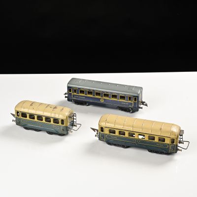 trois trains miniatures posés sur une table l'un à côté de l'autre