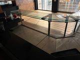 a glass table with a glass top in the middle of a room