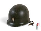 an old helmet is sitting on a white surface with a cord attached to it