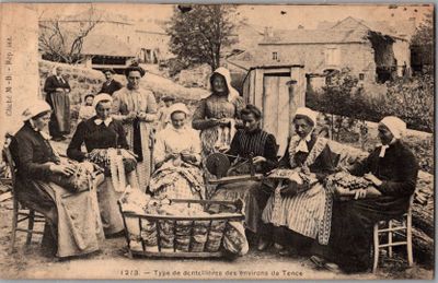 une vieille photo montrant un groupe de personnes assises autour d'un panier de fruits