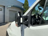 an image of a white van parked in front of a garage