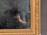 a reflection of a person taking a picture in a mirror