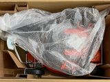 a cardboard box with a plastic bag on top of it and a pair of scissors in it