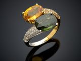 a close up of a yellow and green ring on a black surface